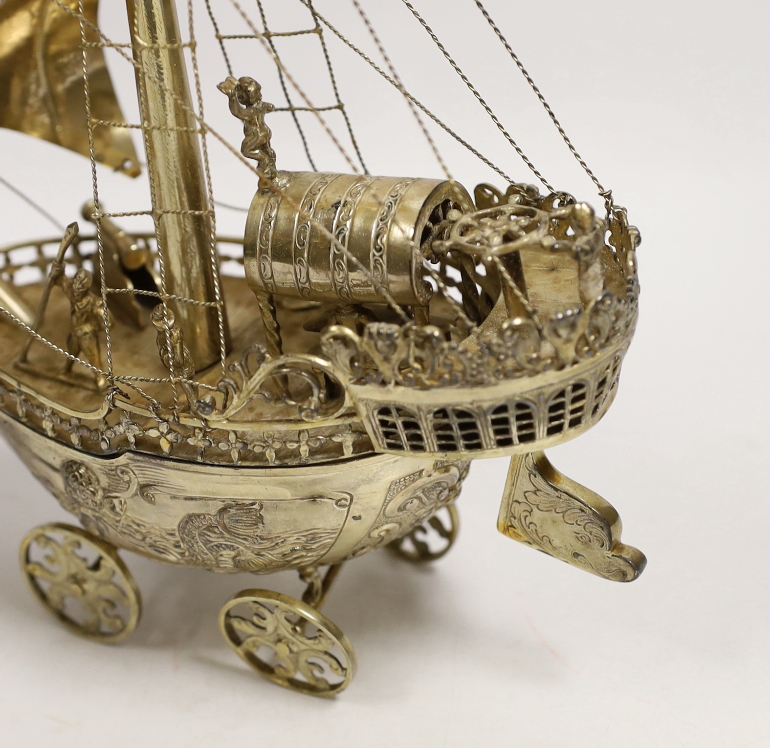 A late 19th/early 20th century Hanau silver gilt model of a Nef on four wheels, possibly by Neresheimer, import marks for A.P.M. London, 1926, height 29cm, gross weight 20.9oz, with detachable base.